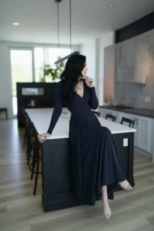 Maxi navy blue long-sleeve infinity fitted wrap dress, reversible with v-neck or boat neck options, and provided with long waist ties.