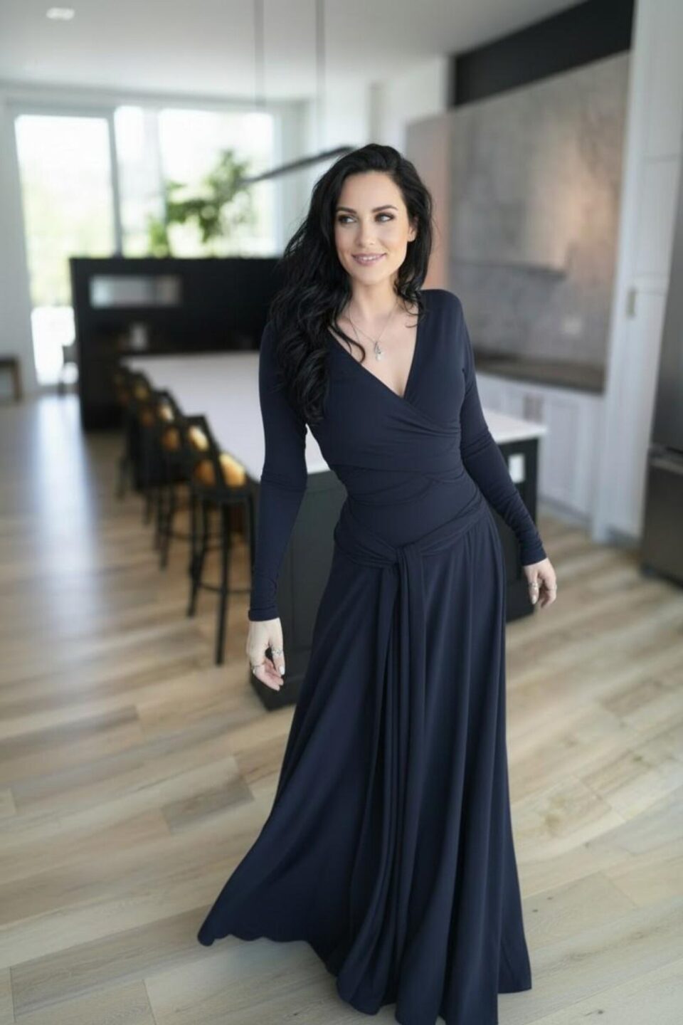Maxi navy blue long-sleeve infinity fitted wrap dress, reversible with v-neck or boat neck options, and provided with long waist ties.