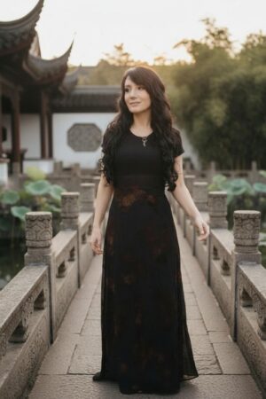 Empire waist cap sleeve maxi dress with mesh overlay and brown velvet floral stencil atop the mesh.